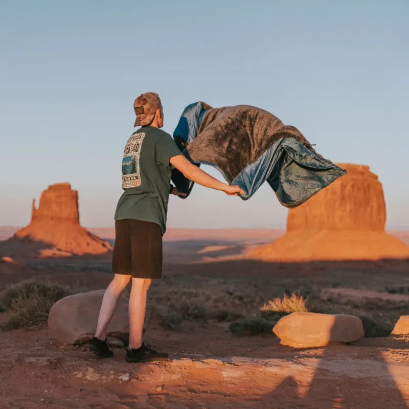 Versa Luxe Blanket folded into a compact pillow, showcasing its versatility for easy storage and travel.