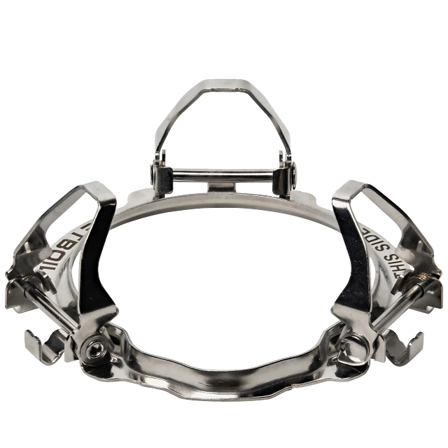 Jetboil Pot Support 2.0 securely attached to a Jetboil burner, supporting a Summit Skillet for backcountry cooking. A camper is flipping food in the skillet over the flame.