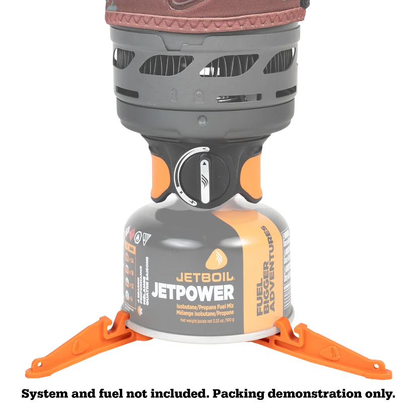 Jetboil canister stabilizer supporting stove on dirt terrain