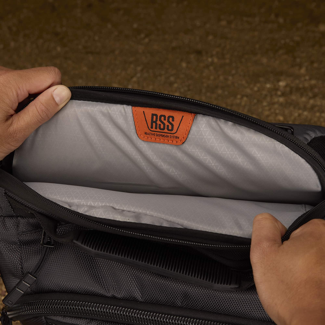 Backpack main compartment showing internal stretch mesh and zip pockets