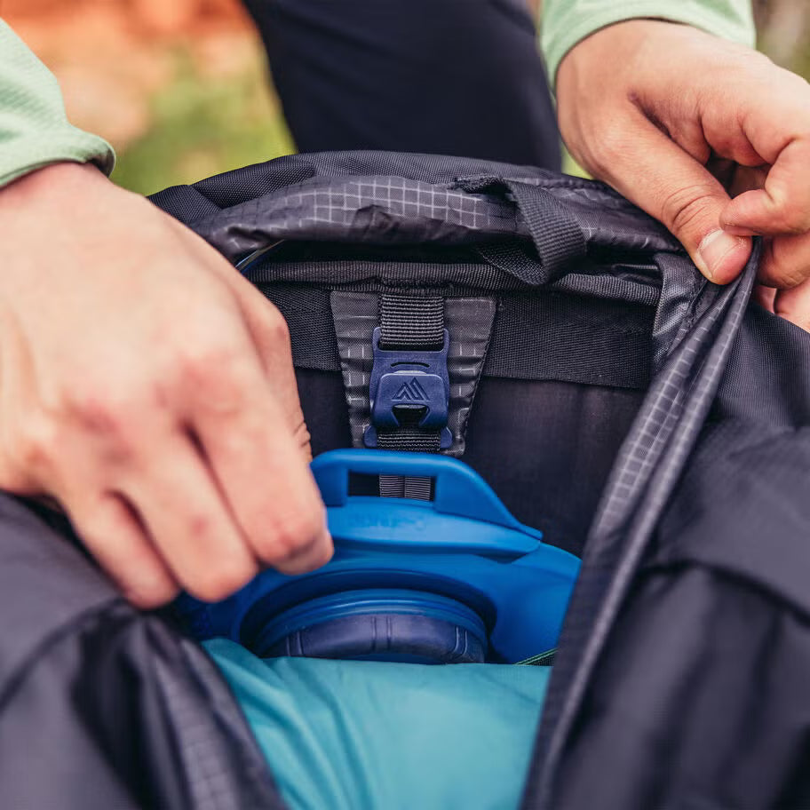 Durable backpacking backpack with sleeping bag compartment and trekking pole attachment