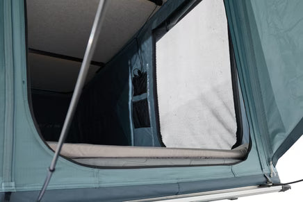 Thule Widesky rainfly providing shaded entry to rooftop tent