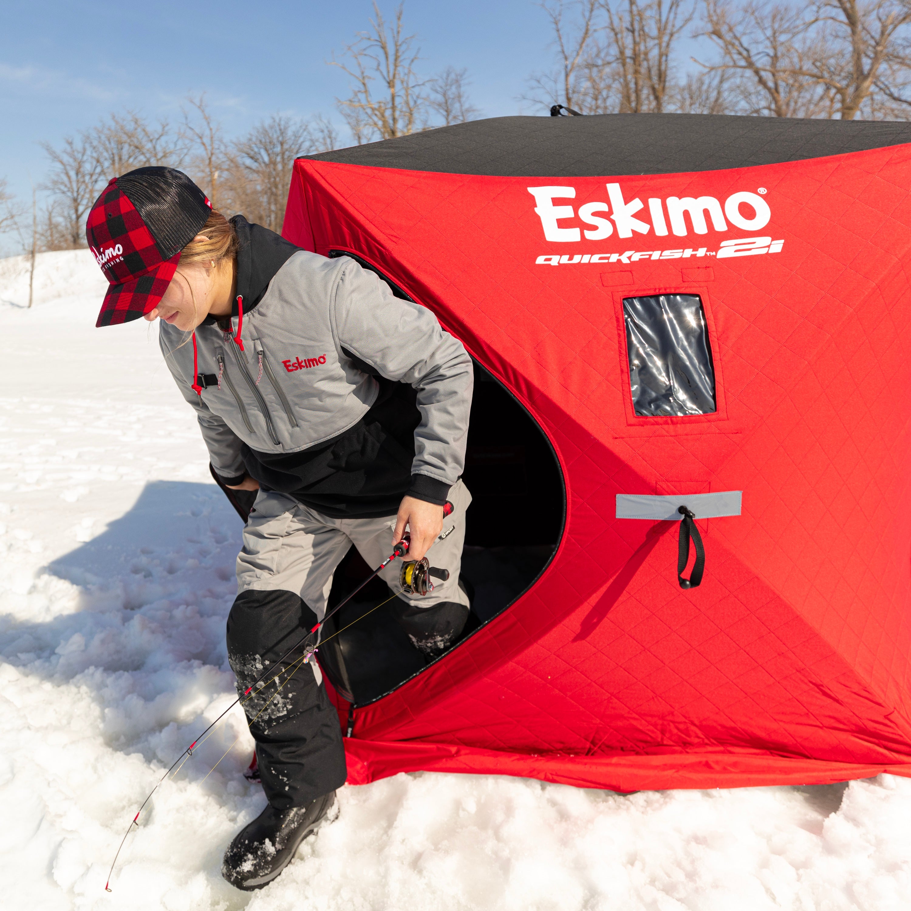 The QuickFish 2i ice shelter being set up with its pop-out hub panel design for quick assembly.