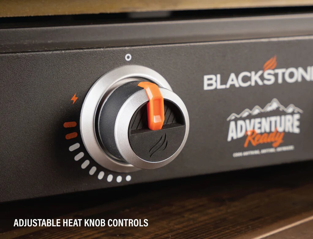 Blackstone Adventure Ready grill with adjustable heat knob controls on a wooden surface