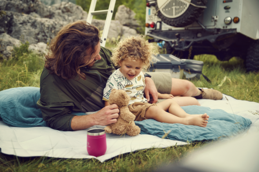 Dometic blanket used as a base for beach gear, demonstrating water and dirt resistance.