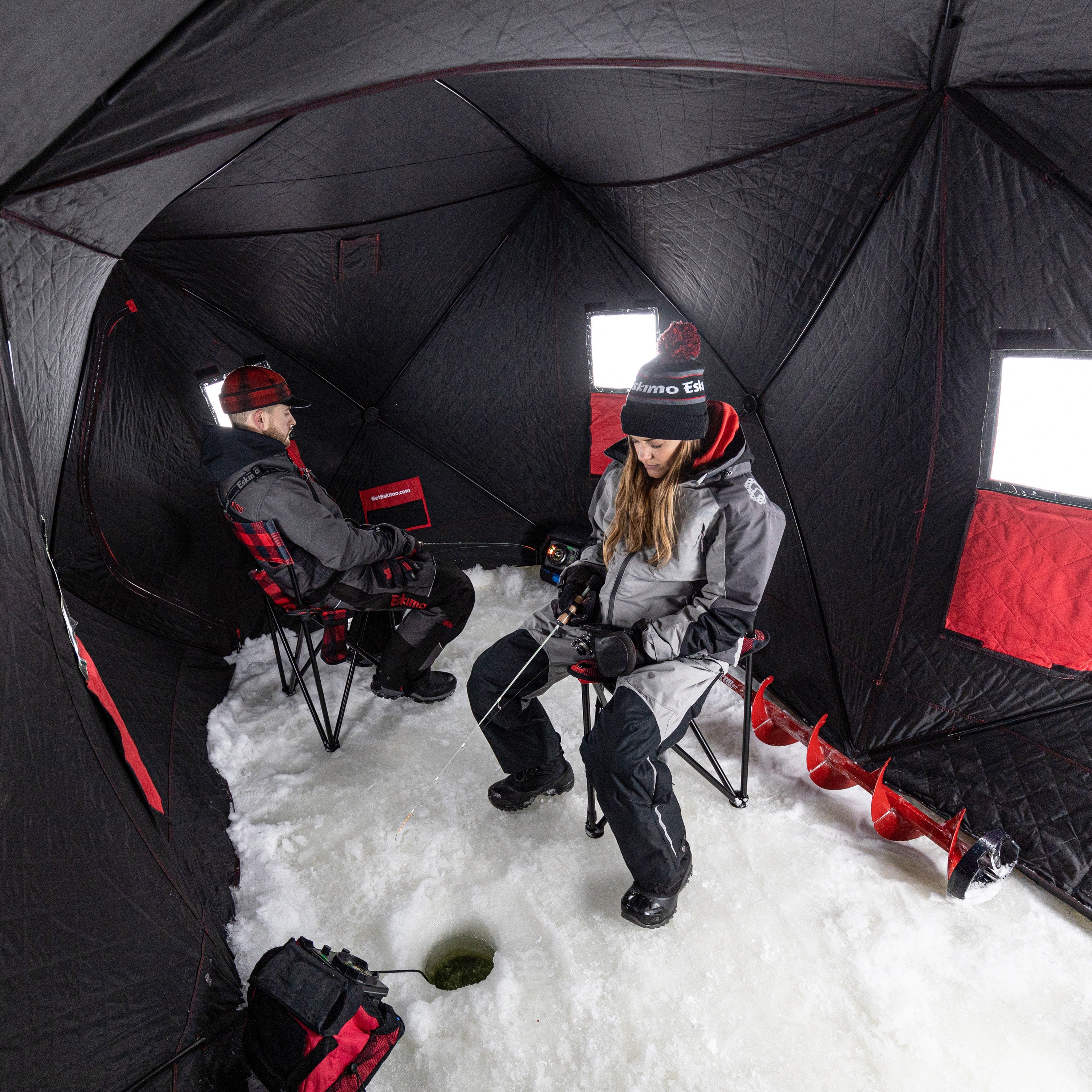 Collapsed QuickFish™ 6i ice fishing shelter in its compact carrying bag for easy storage and transport