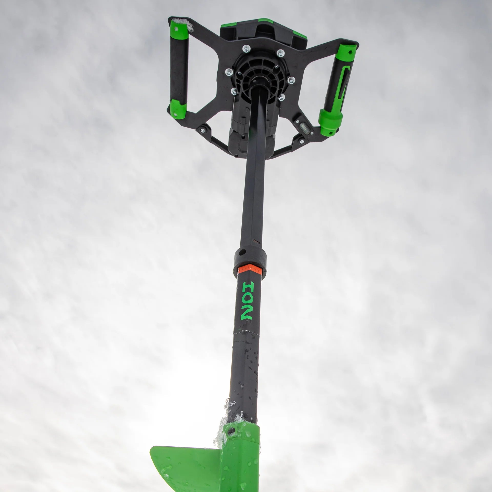 Green and black ice axe on a white background