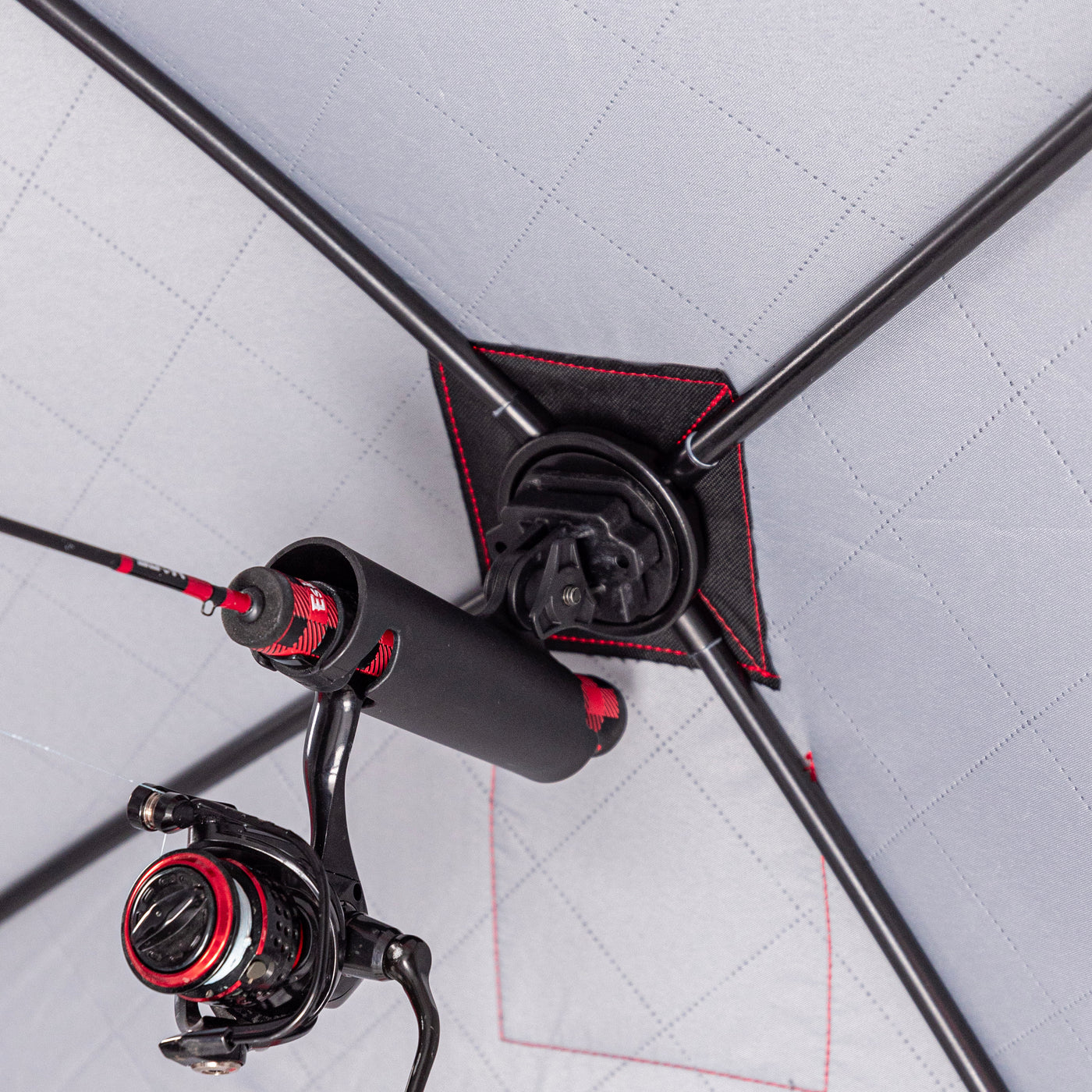 Ice fishing deadstick holder with reel-securing pocket design