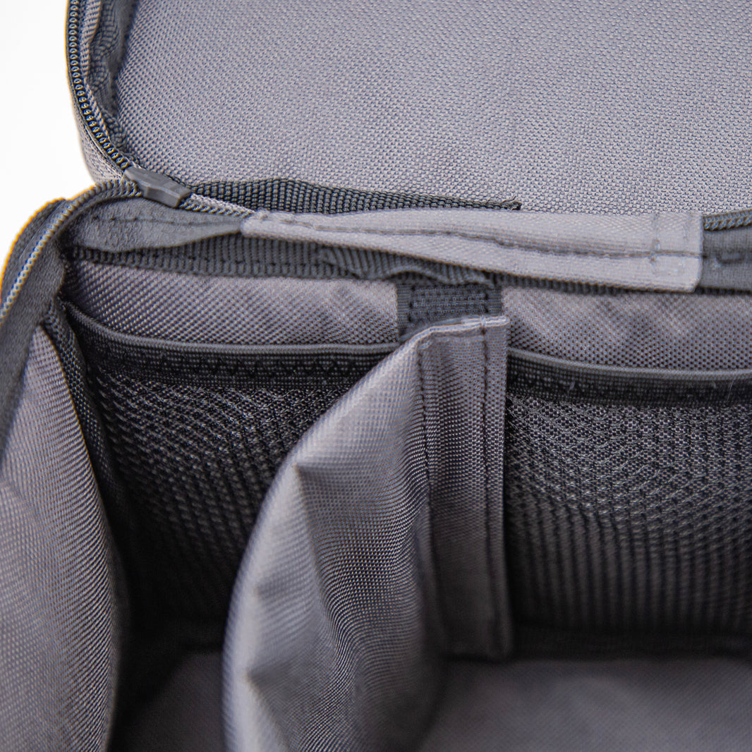 Close-up of a gray bag with mesh pocket and zipper