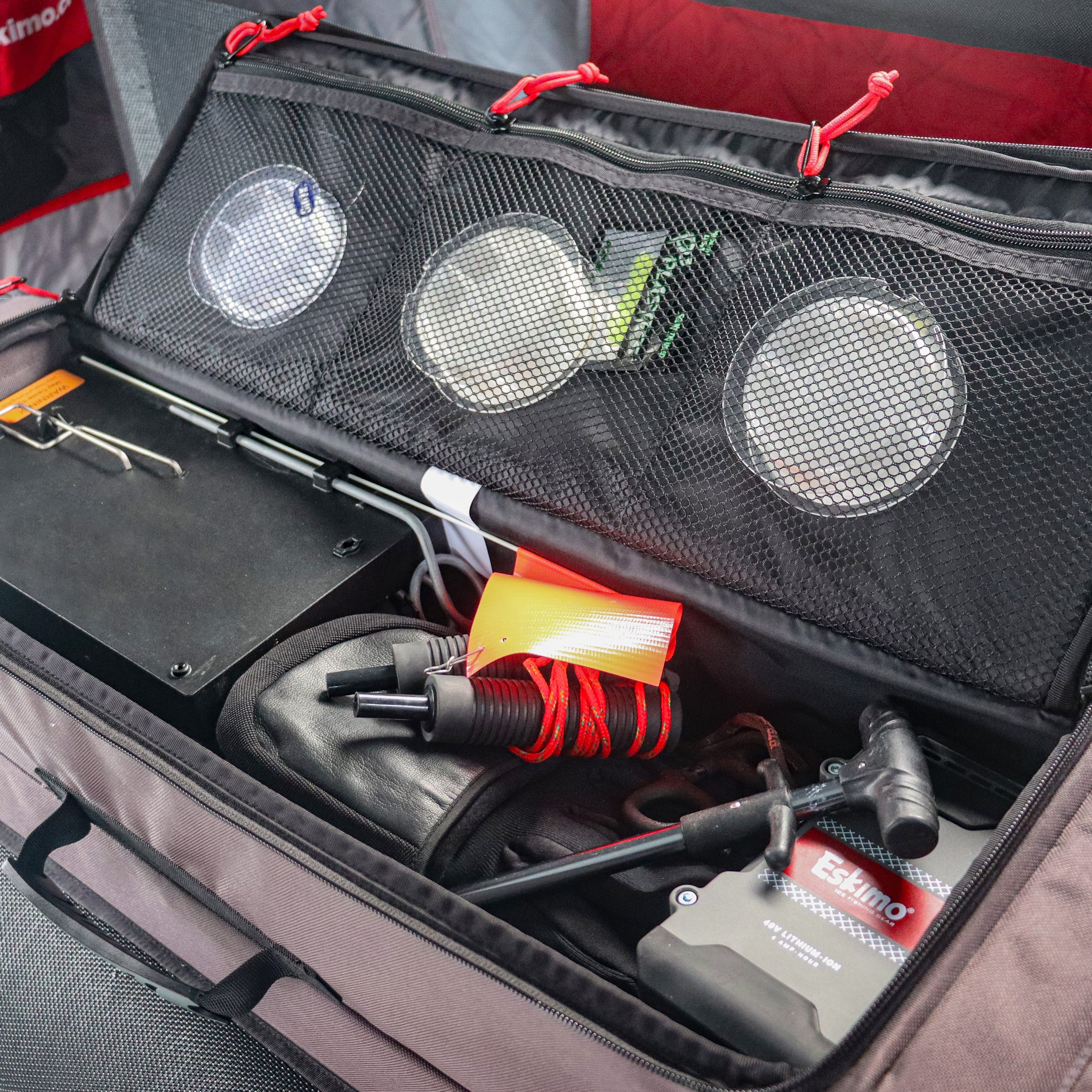 Zippered central gear compartment on Eskimo 42-inch rod locker for tackle, tip-ups, gloves, and accessories