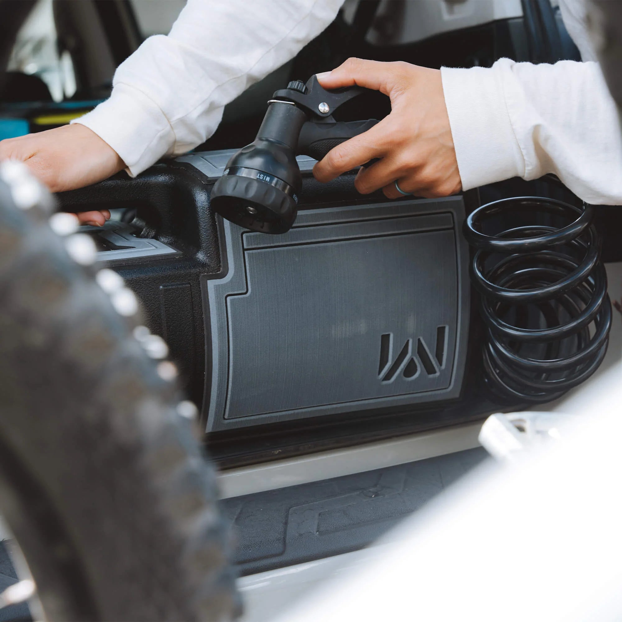 Peeling back the 3M adhesive layer on the EVA Tank Wrap for easy application