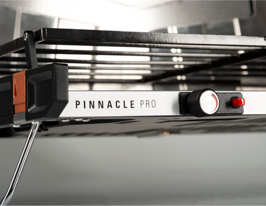 Pinnacle Pro Stove showing retractable legs and high-efficiency burners