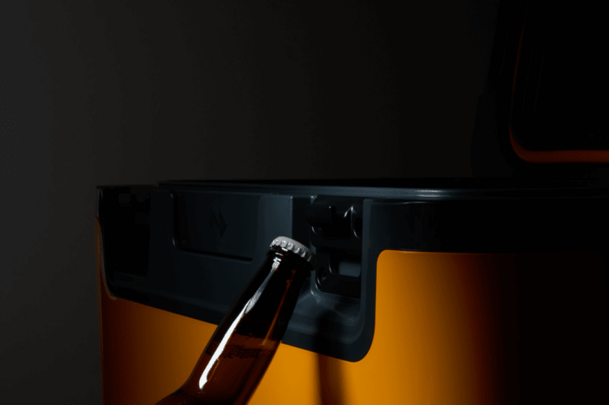 Recon hardside cooler with insulated drain plug and magnetic attachment