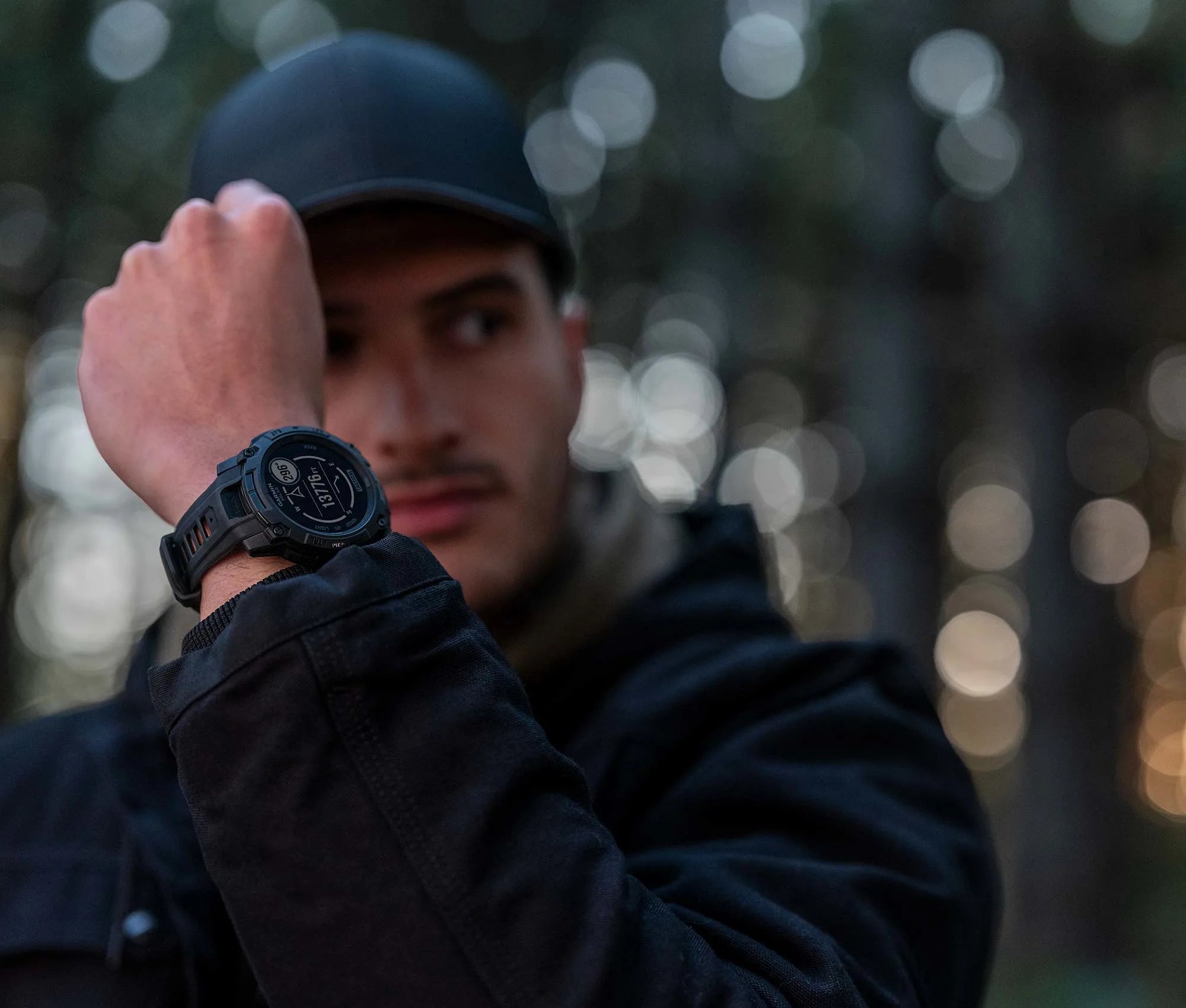 Man wearing a black watch with a blurred background