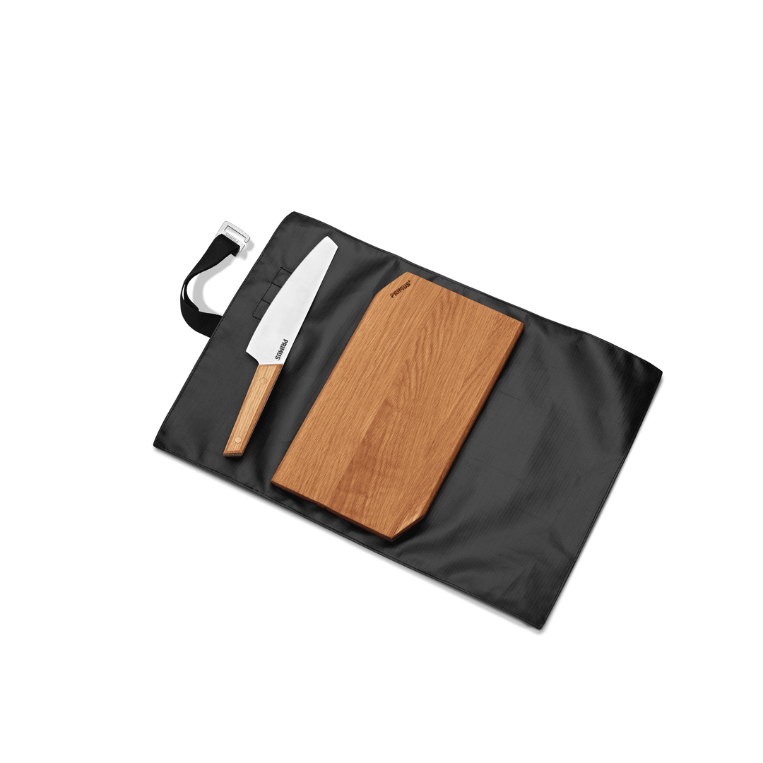 Compact camping knife and oak cutting board set for food prep at the campsite