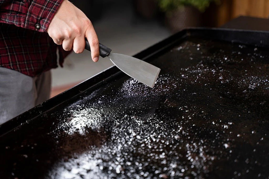 Two resurfacing stones for deep cleaning and re-seasoning the griddle.