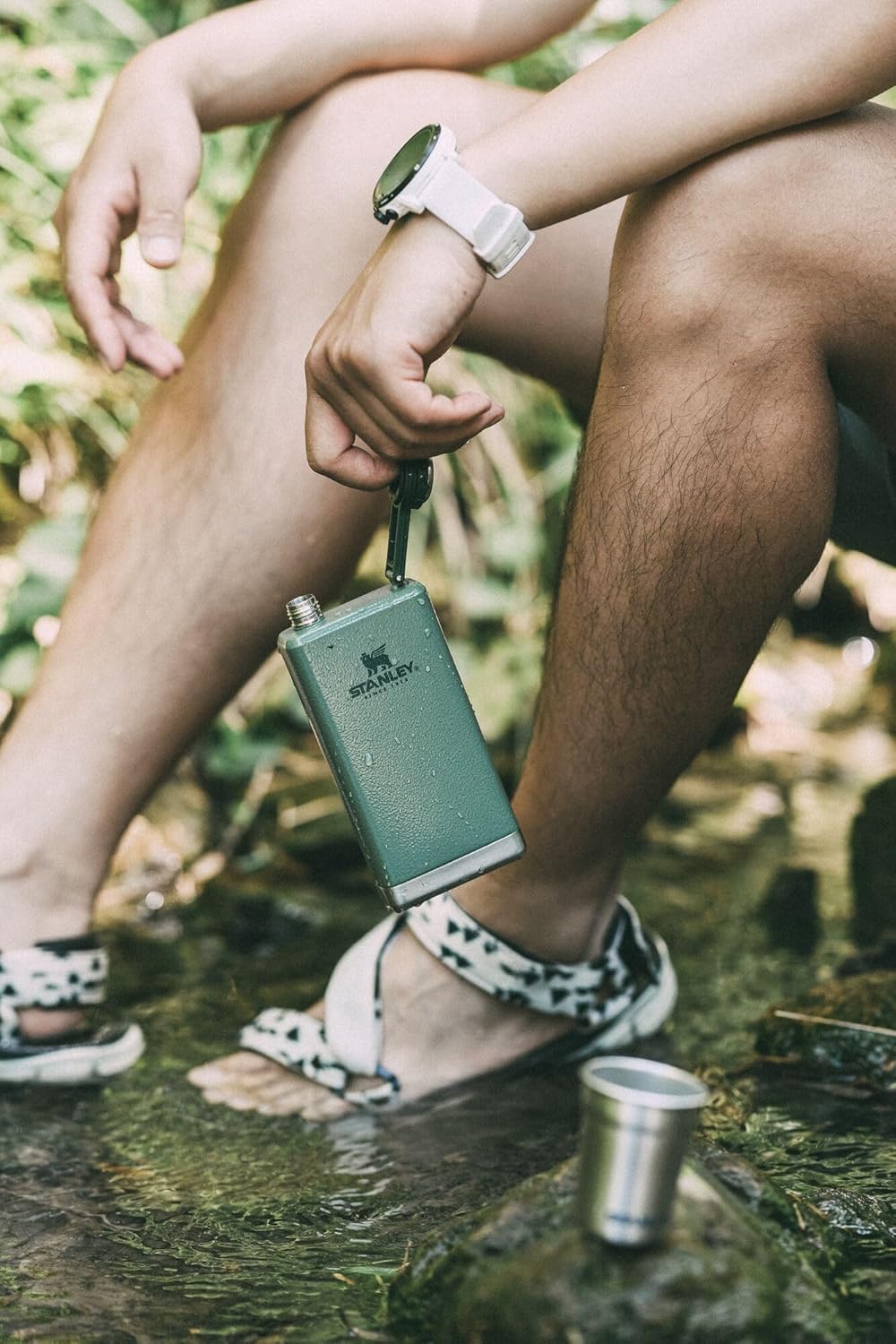 A beautifully wrapped gift box containing a Stanley 8oz Pre Party Flask, surrounded by festive decorations, highlighting its appeal as a perfect gift for birthdays or special occasions