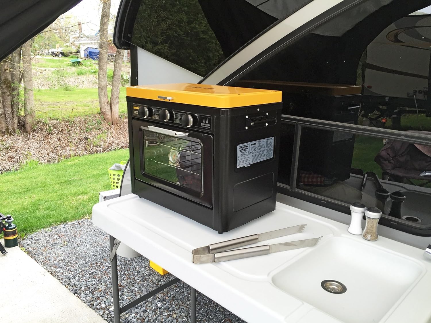 lose-up of two 10,000 BTU brass burners with wind shields on the Martin MOS-24 portable propane stove.
