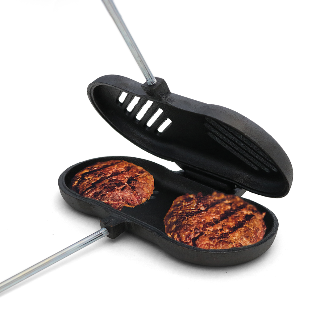 Black burger press with two cooked burgers on a white background