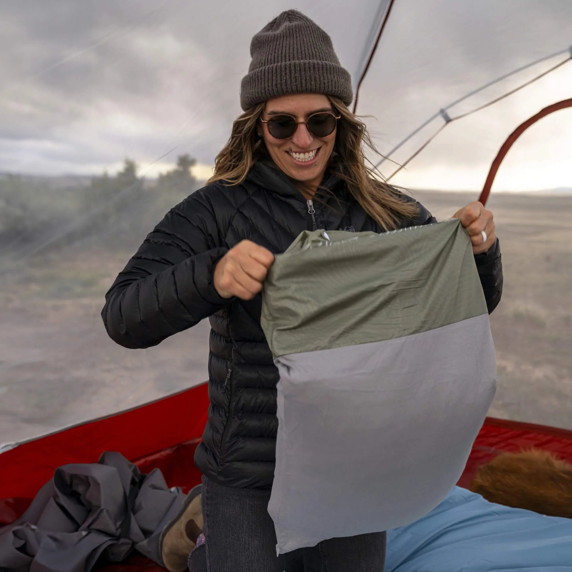 The Drift Pillow partially unzipped to show its shredded memory foam filling and soft jersey cotton inner pillowcase, designed for a balance of comfort and support.