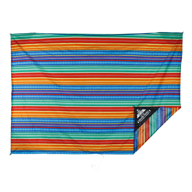 Water-resistant adventure blanket with attached stuff sack and corner anchor pockets