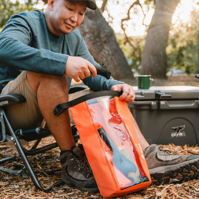Outdoor survival kit with emergency blanket, dry bag and rescue whistle
