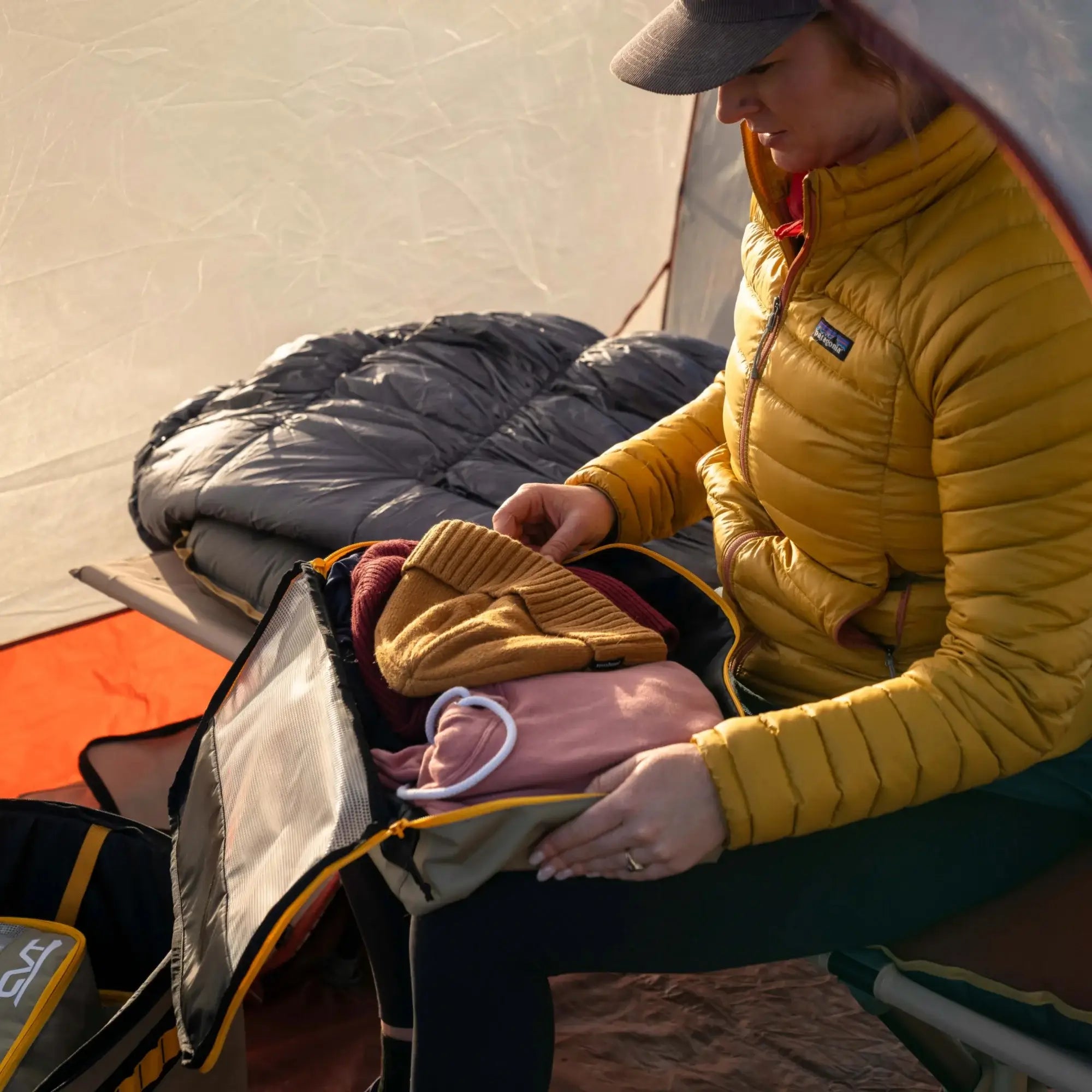 A partially unzipped CVT Camping Cube revealing neatly packed clothing and accessories, highlighting its spacious and organized interior