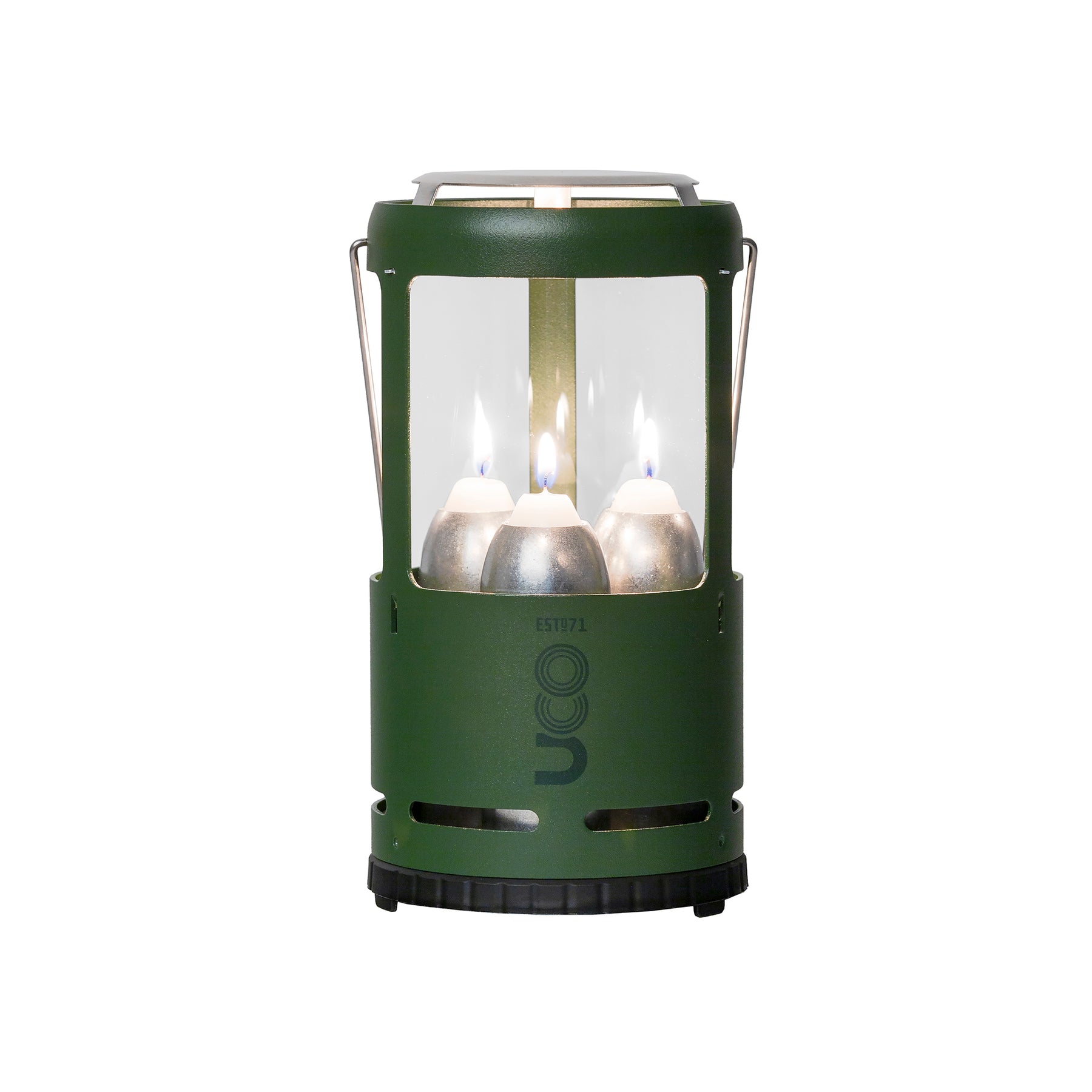 UCO Candlelier Candle Lantern glowing warmly on a campsite picnic table, with a mug resting on the heat shield.