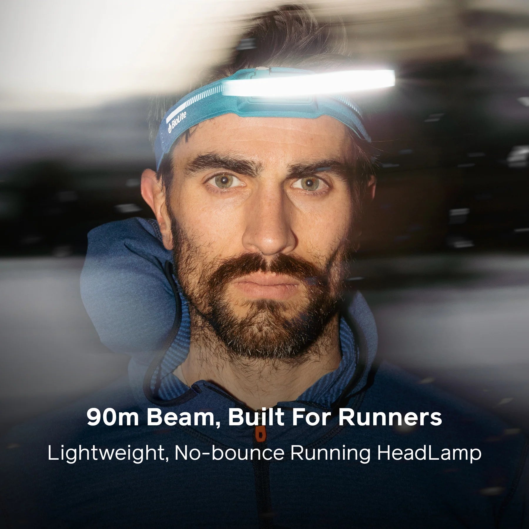 A bright white spot beam illuminating a trail ahead, demonstrating the 90m beam distance.