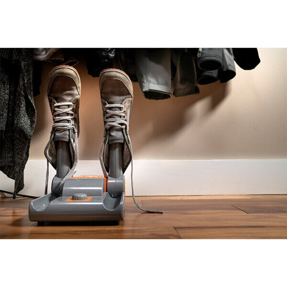 Shoe dryer on a wooden floor with shoes on top