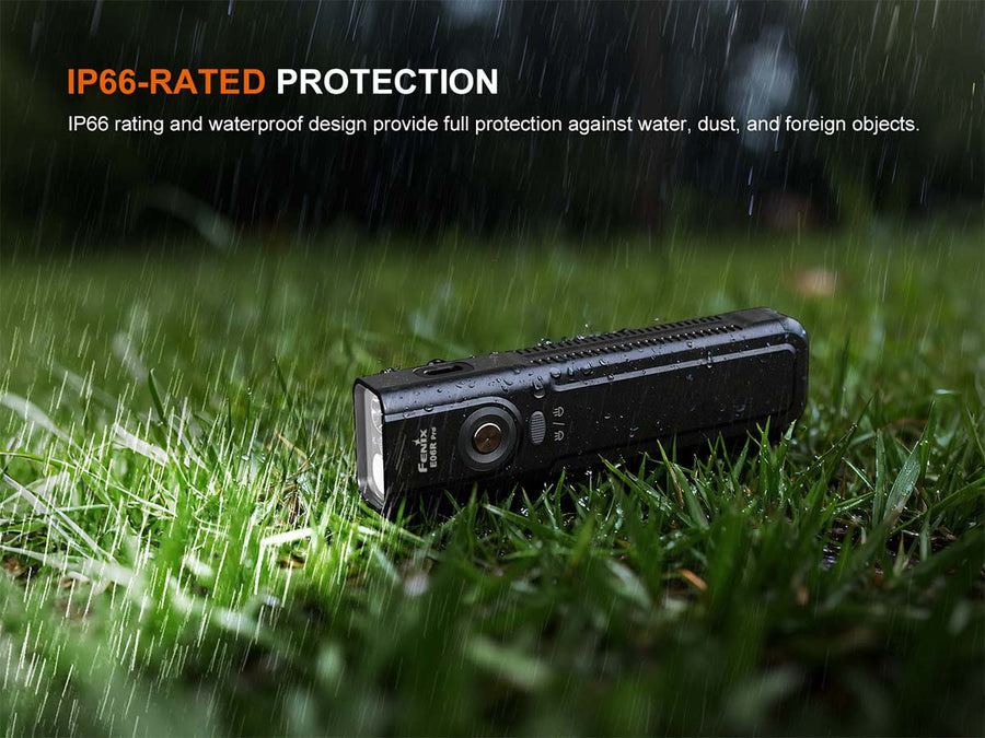 Black flashlight on grass with raindrops and IP66 rating text