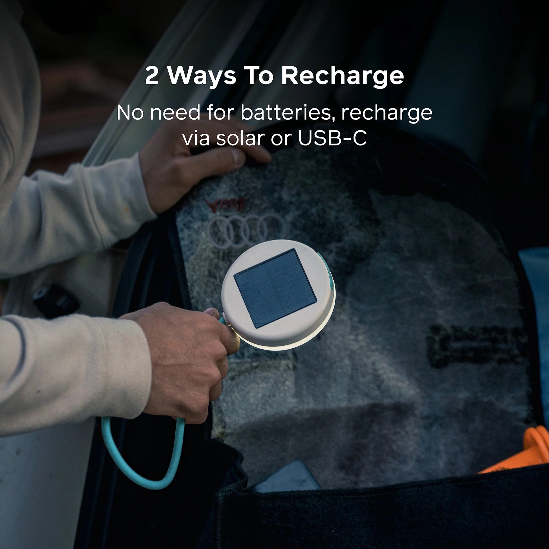 Person holding a device with solar panel and USB-C cable, with text about recharge options.