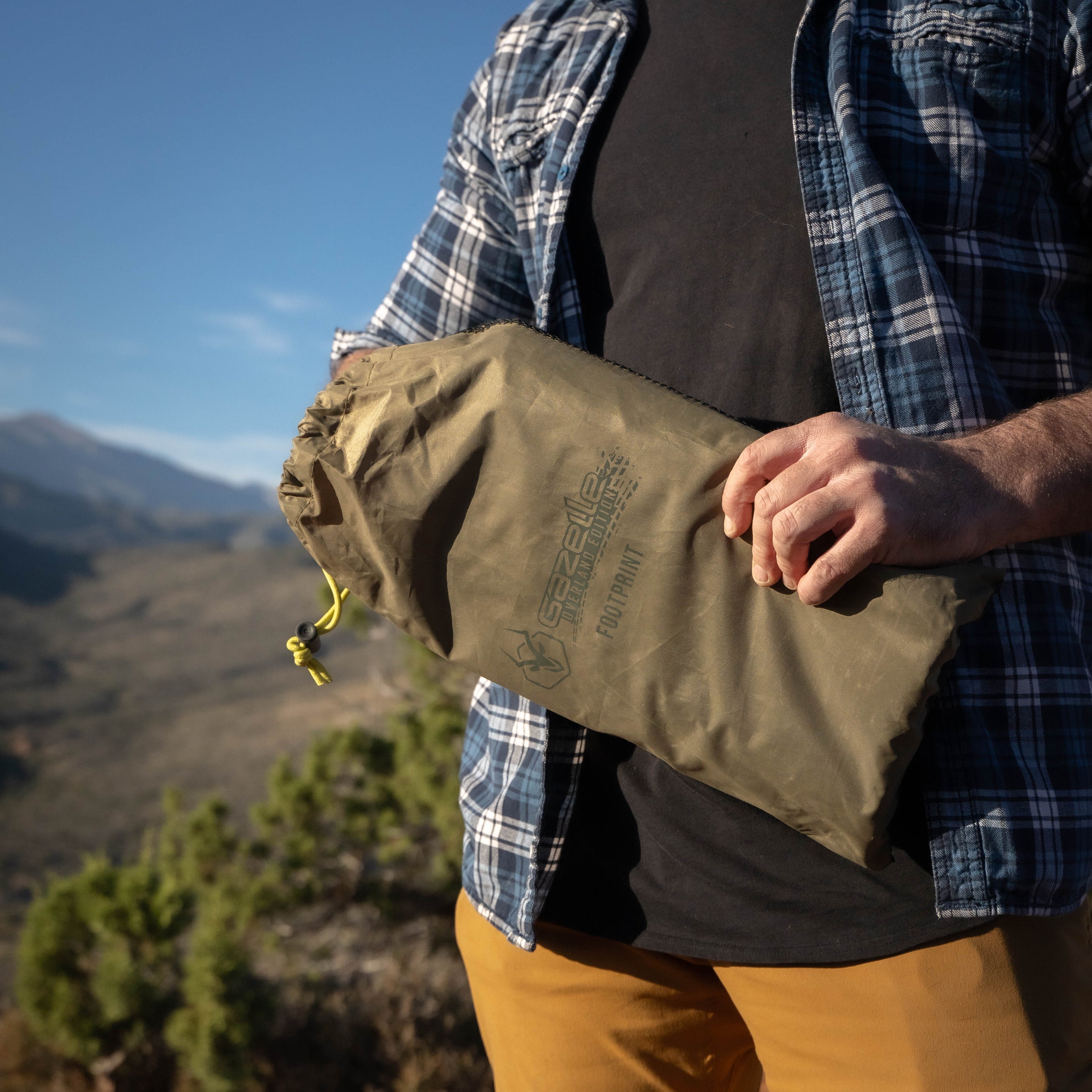 Gazelle T4 Hub Tent Overland Edition packed into an oversized water-resistant duffle bag for easy transport.