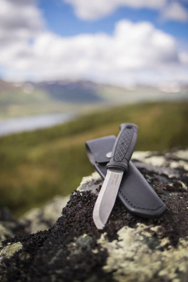 Morakniv Garberg full tang knife in outdoor environment, ideal for tough tasks like wood processing and survival situations