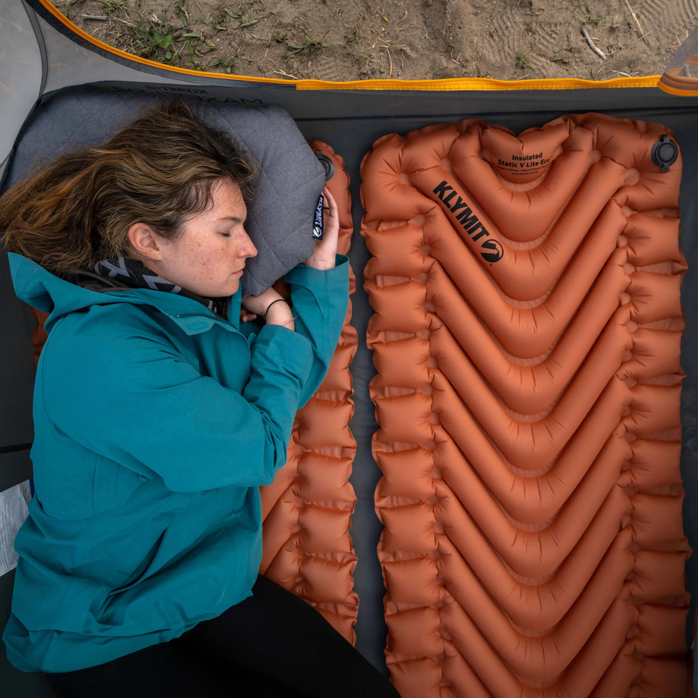 Side rails on the sleeping pad that help keep user centered while sleeping