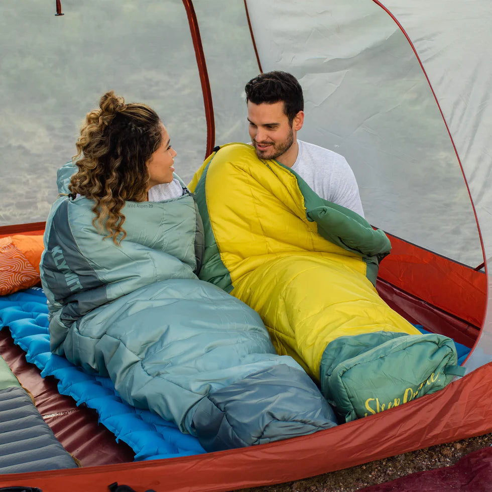 Wild Aspen 0 sleeping bag packed into its included compression sack for compact storage and easy transport.