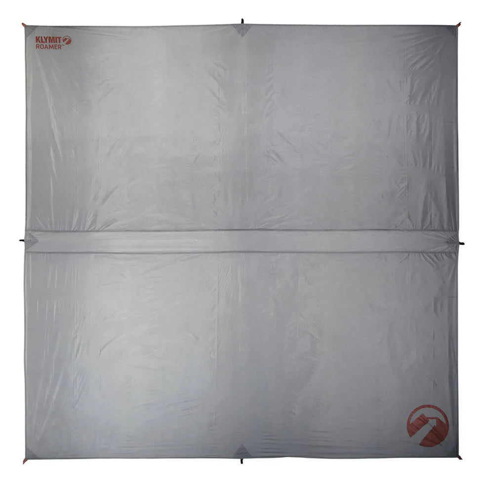 Roamer Throw Tarp set up as a lean-to shelter, providing shade and protection from the elements in an outdoor setting