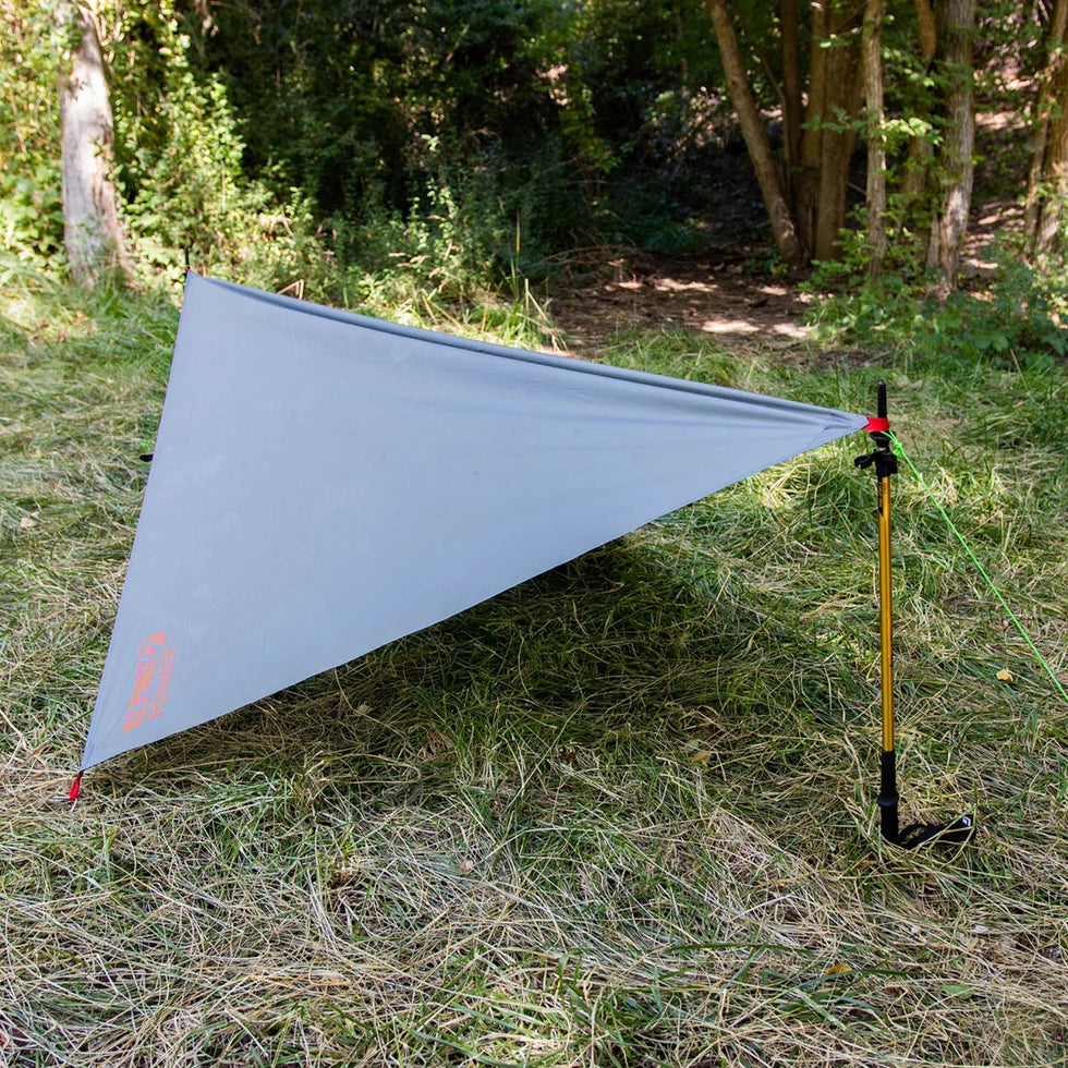 Roamer Throw Tarp neatly folded and packed into a compact carrying bag, demonstrating its lightweight and travel-friendly design.