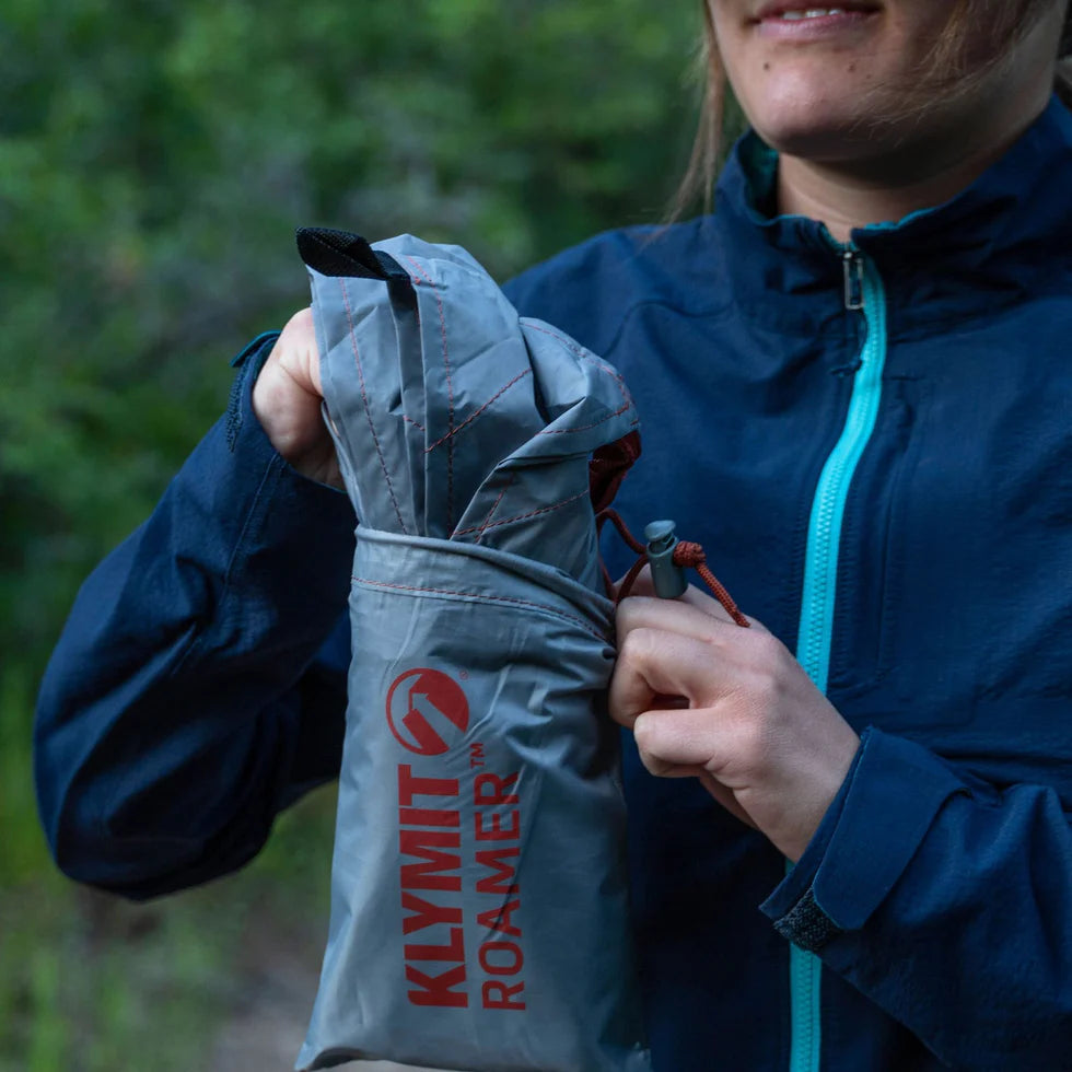 Close-up of water droplets beading up on the 75D polyester fabric of the Roamer Throw Tarp, highlighting its 3000mm waterproof coating