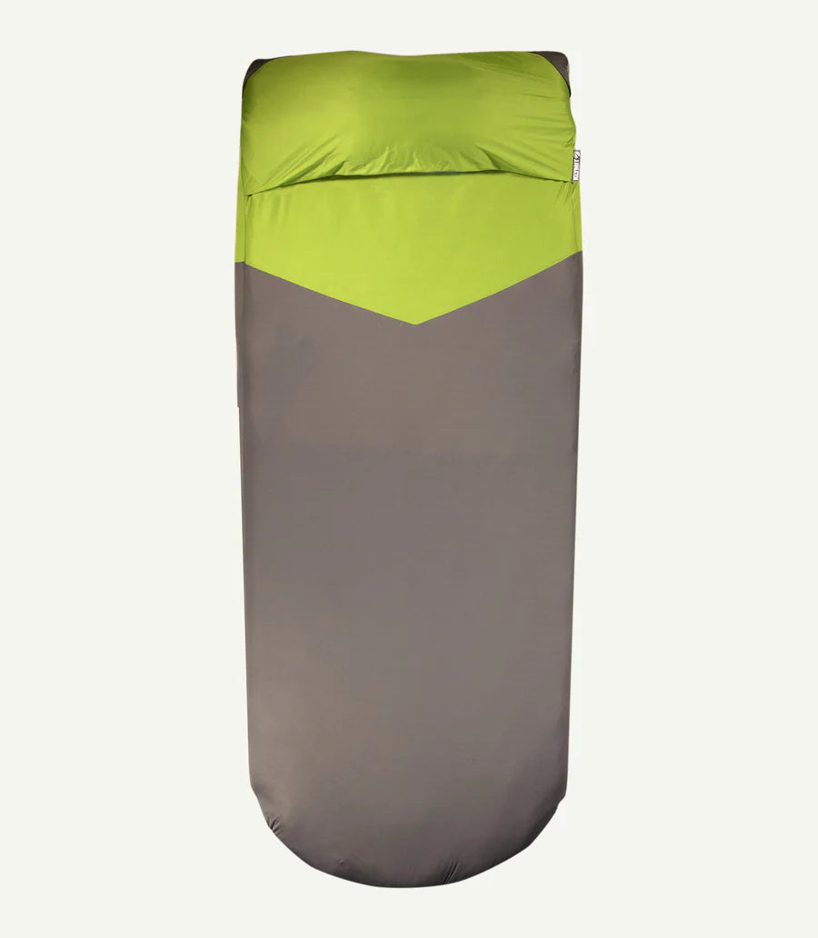 A soft, fitted stretch polyester sheet snugly covering a sleeping pad, with a pillow securely placed in the built-in pocket. Showcases its comfort and functionality for camping use.