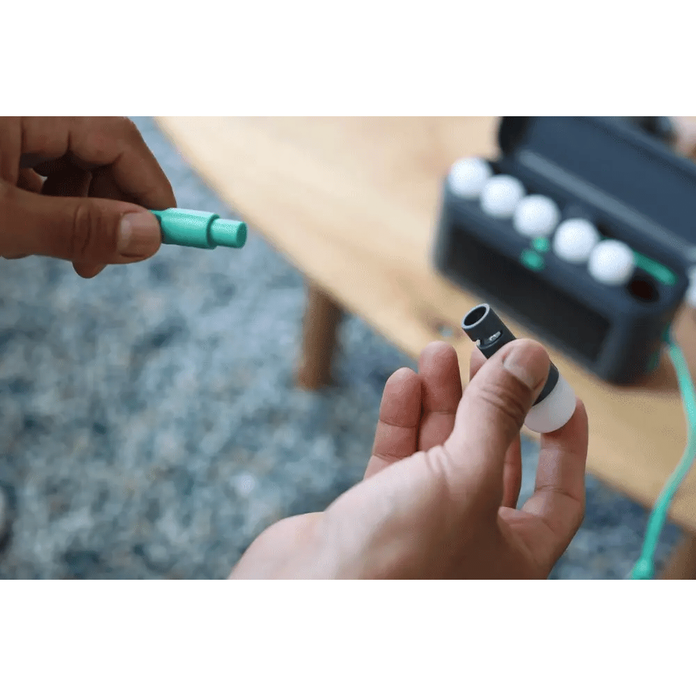 Person holding a small electronic component with a blurred background