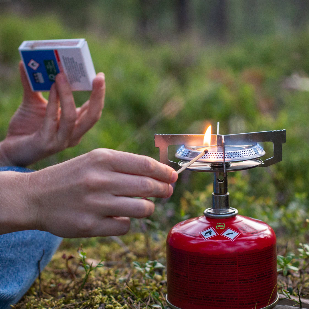 Durable Classic Trail Stove cooking a meal in large pot for up to three people, wide flame visible.