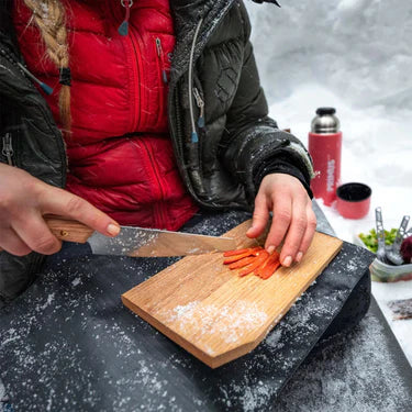 Oak handle on camp knife offers ergonomic grip and comfort during outdoor food prep