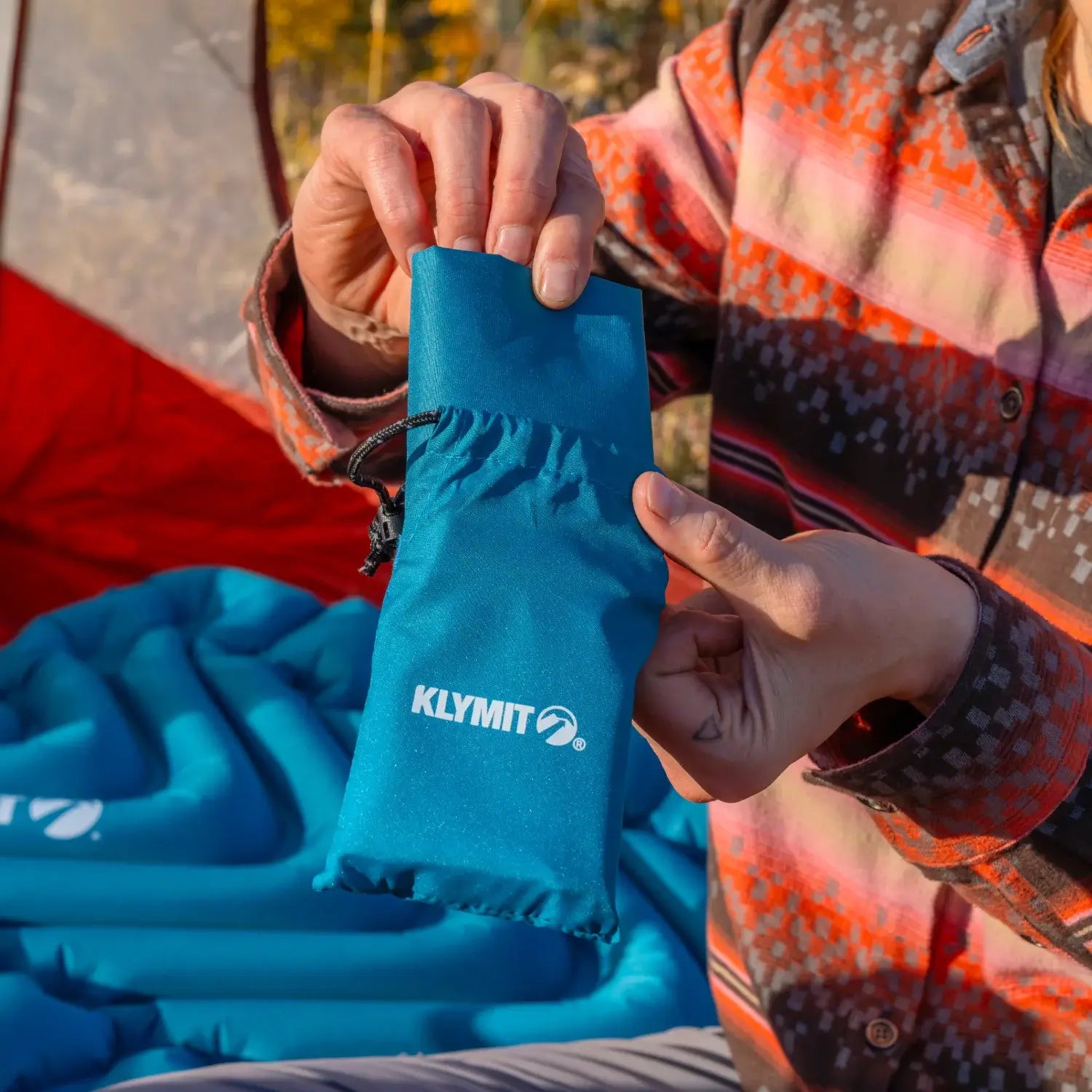 Compact inflatable camp pillow with welded X support pattern