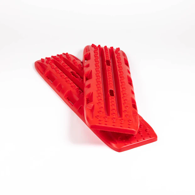 Red dog grooming tool with textured surface on a white background