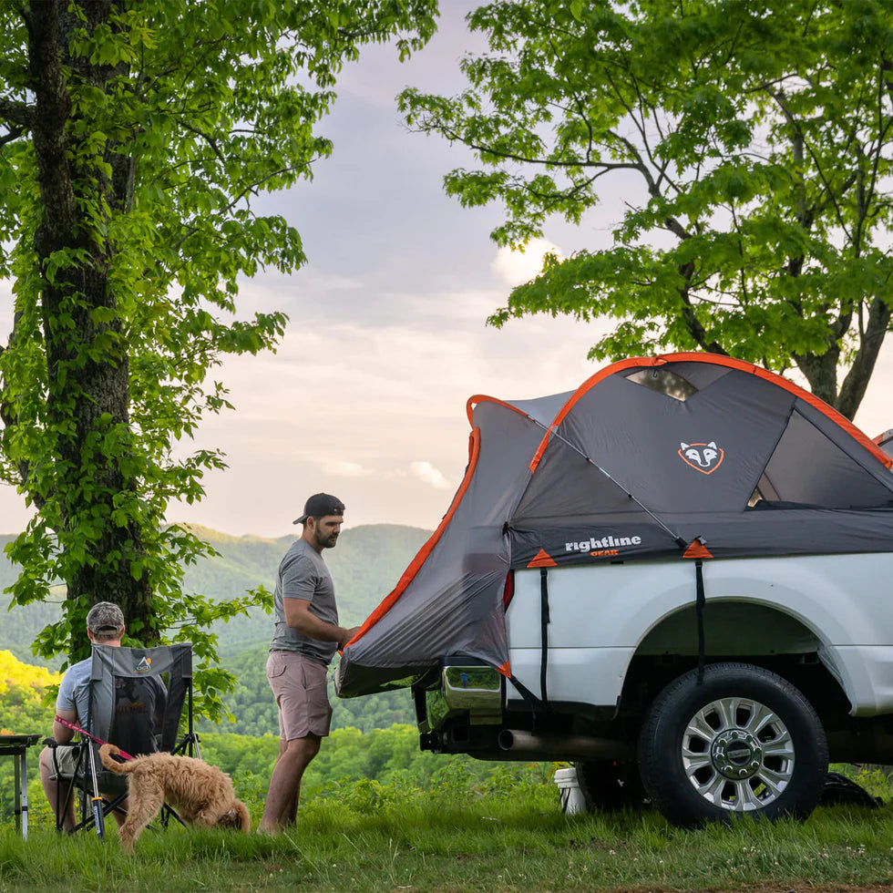 Two adults comfortably sleeping inside the Truck Tent, demonstrating its spacious design