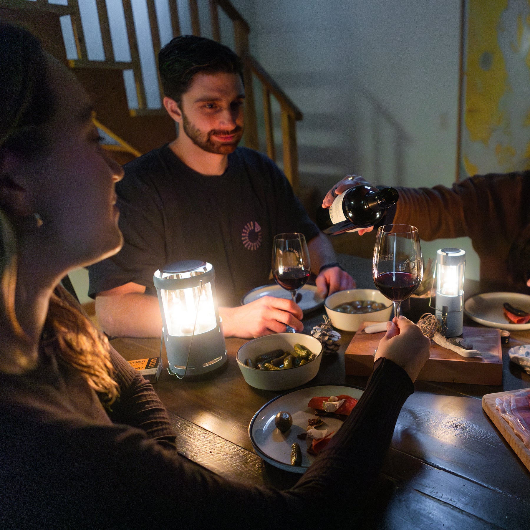 Close-up of the UCO Candlelier heat shield keeping a mug of coffee warm, with visible steam rising.