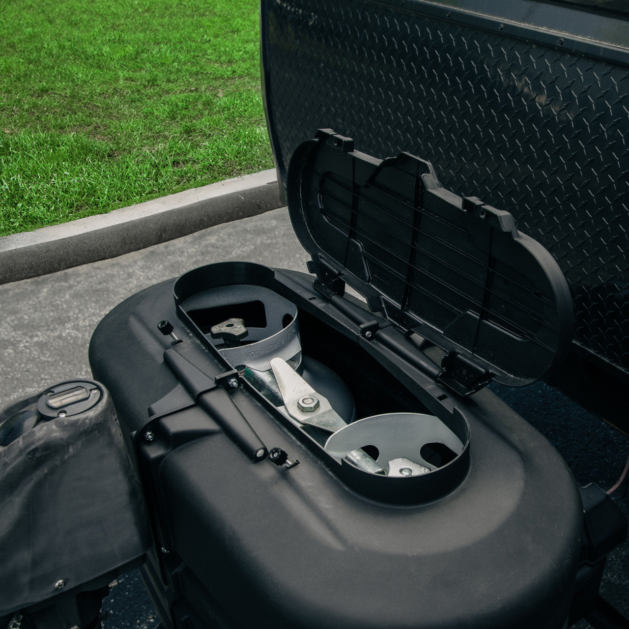 Camco RV propane tank cover installed on an RV, shielding propane tanks from road debris and sun damage.