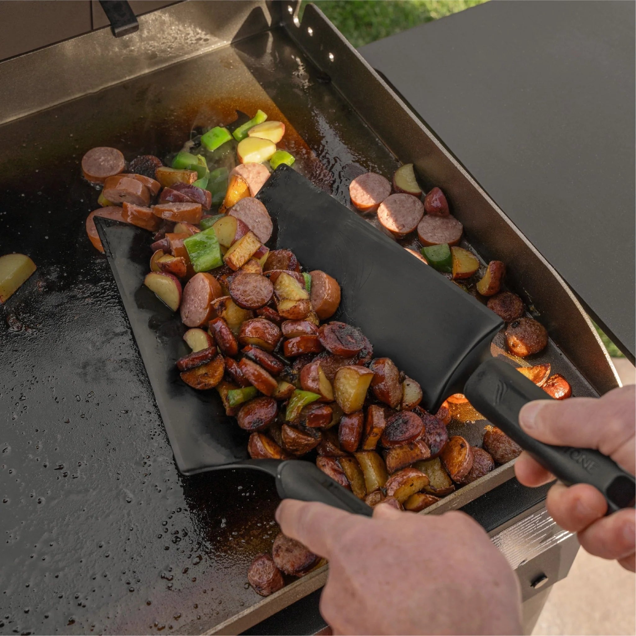 Portable outdoor griddle with wheels and electric push button ignition