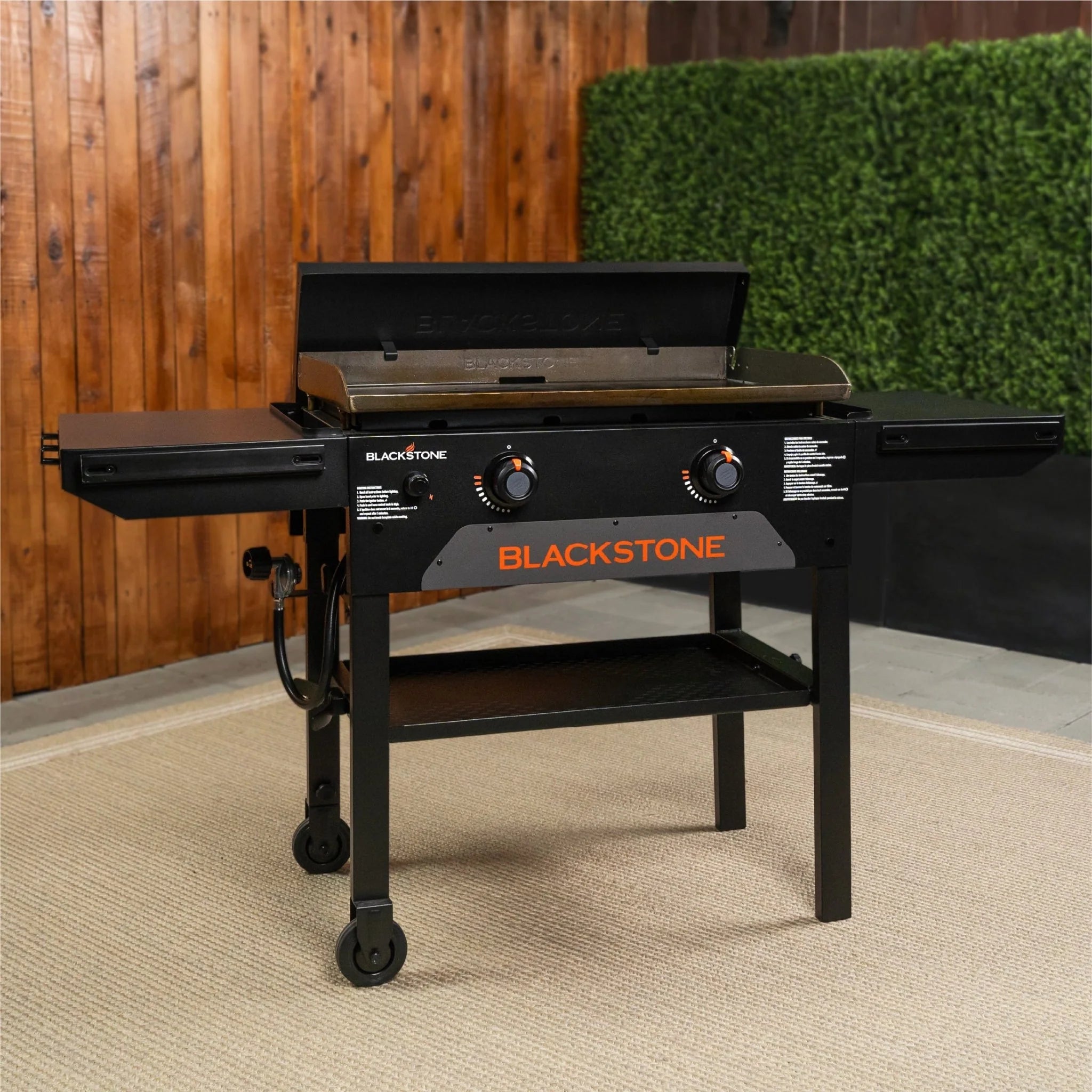 Blackstone griddle with dual side shelves and side shelf hooks for cooking accessories